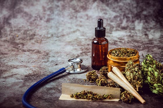 Marijuana products placed alongside stethoscope, showcasing its medicinal value.