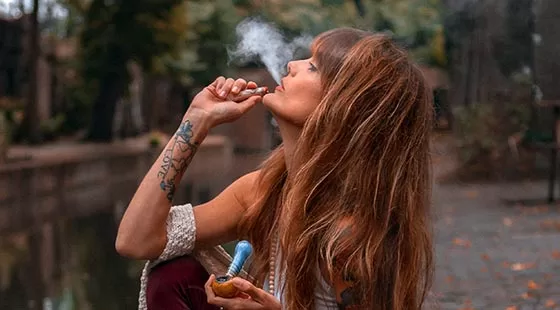 Red haired woman exhaling smoke