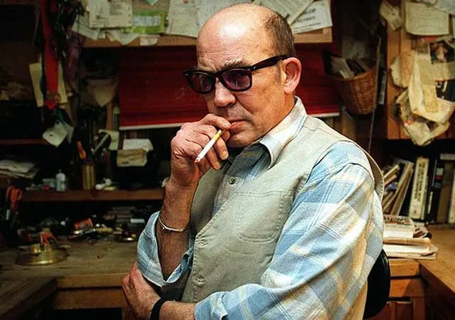 File photo of Hunter Thompson in a study or office, smoking